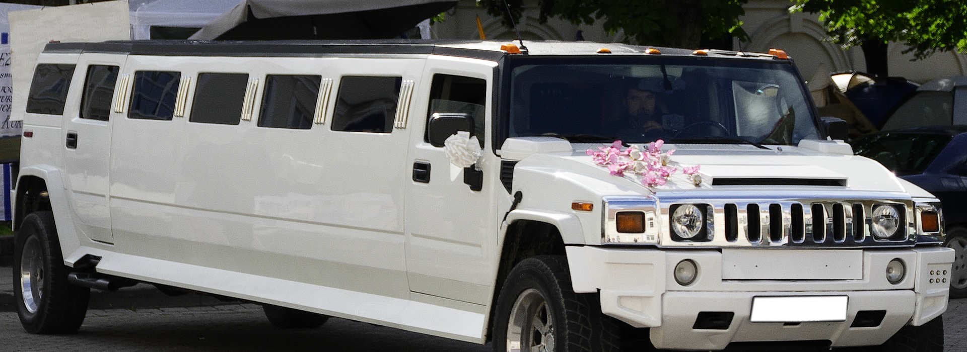 Happy wedding couple with luxury limousine